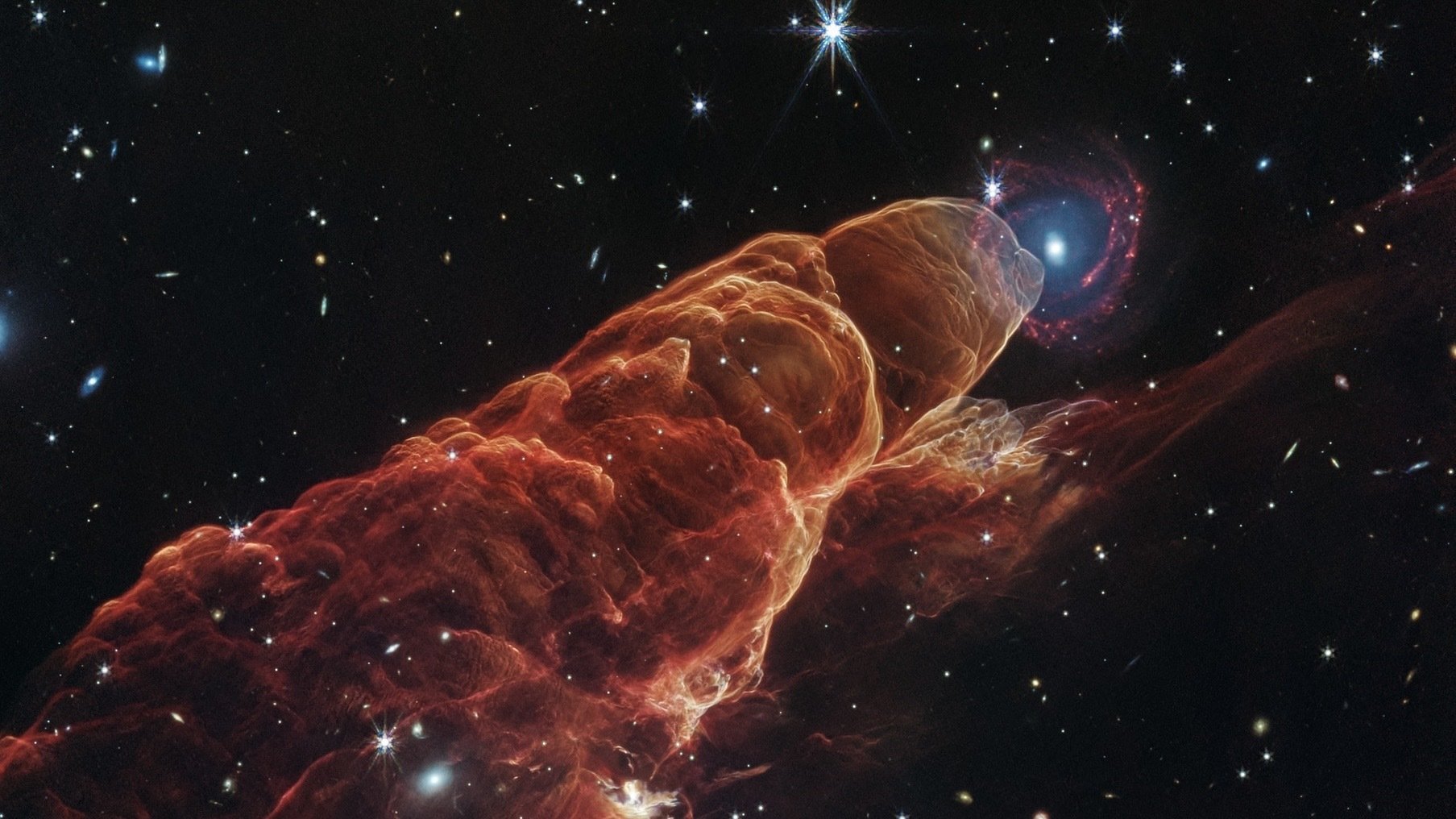 Webb reveals that’s no star over there. It’s an entire freaking galaxy.